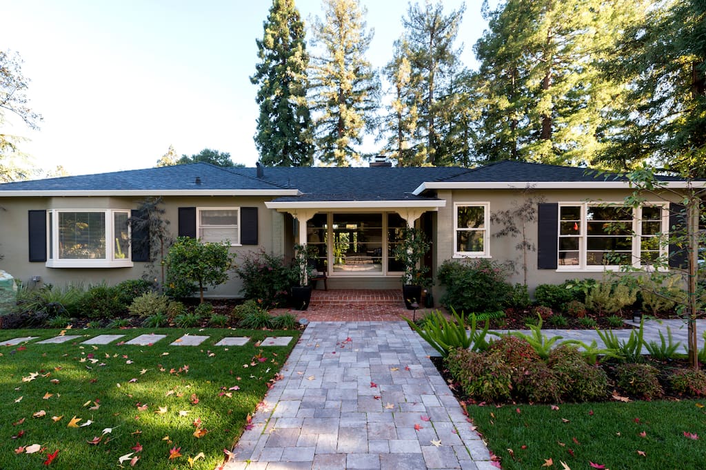 Quiet property with professional landscaping, outdoor lighting,and surrounded by large trees. Master bedroom bay window is on the left.