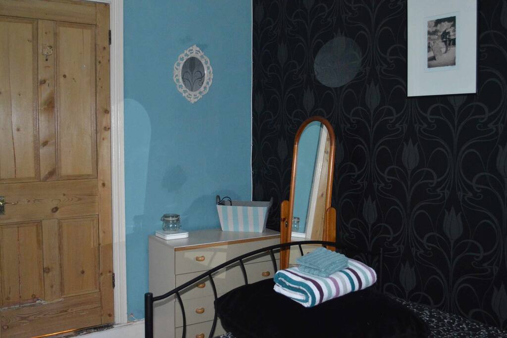 Chest of drawers, full length mirror and vintage style hanging rail are all in place for your convenience.