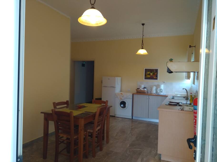 Kitchen with big fridge and washing mashine