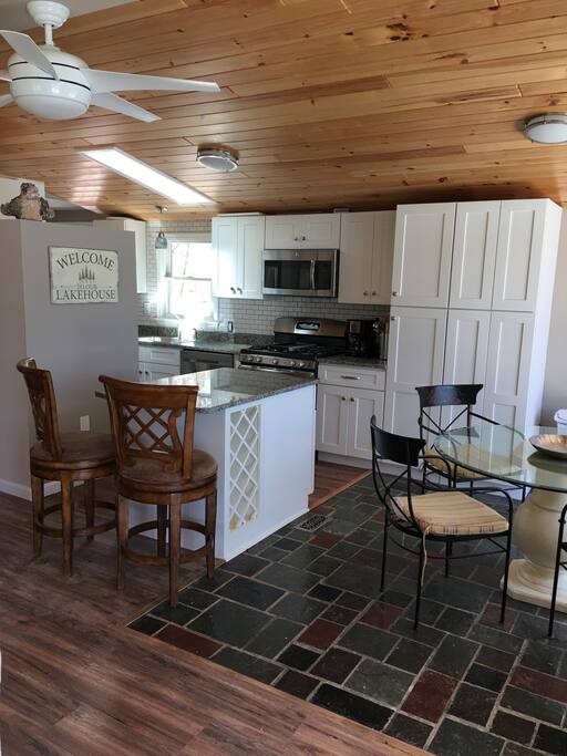 View of the kitchen, island, and glass top table