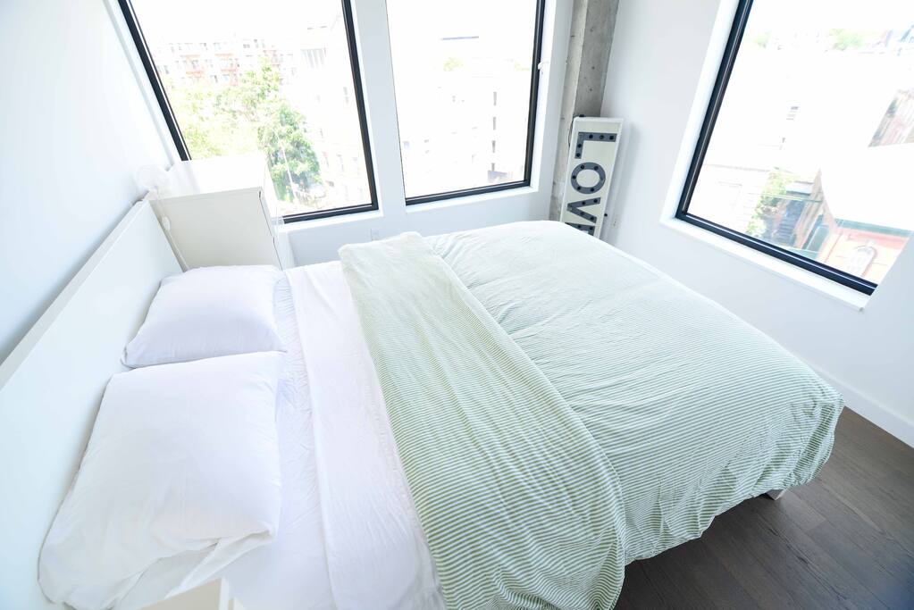 Large windows with white blinds, and an endless view of open sky makes for a lovely morning.