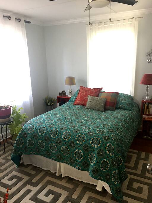 Your private bedroom with a closet, ceiling fan, dresser, down duvet, and nice views into the backyard.