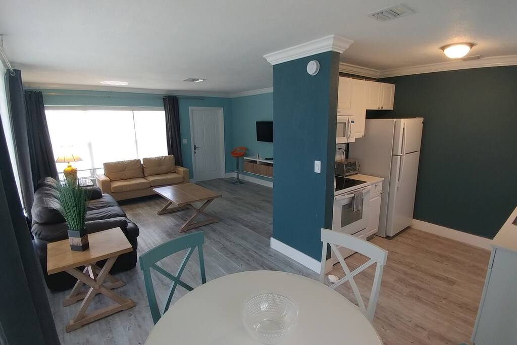 Full view of the apartment living room, sofa bed, TV, Kitchen and Dining Table