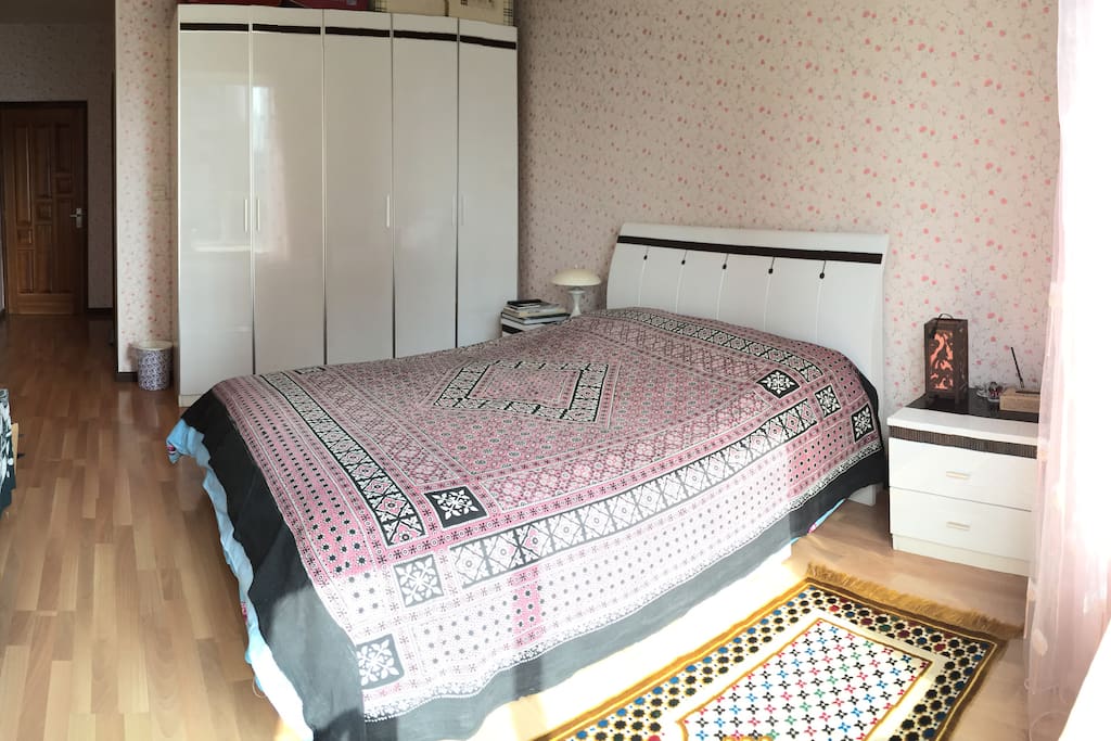 Sunny master bedroom with an attached bathroom