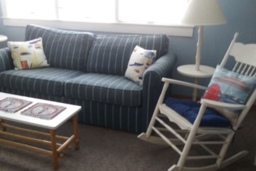 living room area with large flat tv. new queen sofa bed