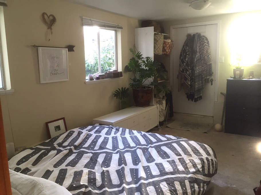 Queen Size Bed with lots of south facing garden-filtered light. Door to sweet little backyard.