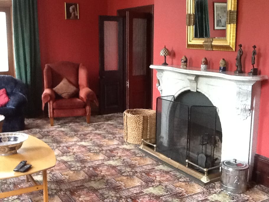 Large sitting room with marble fireplace.