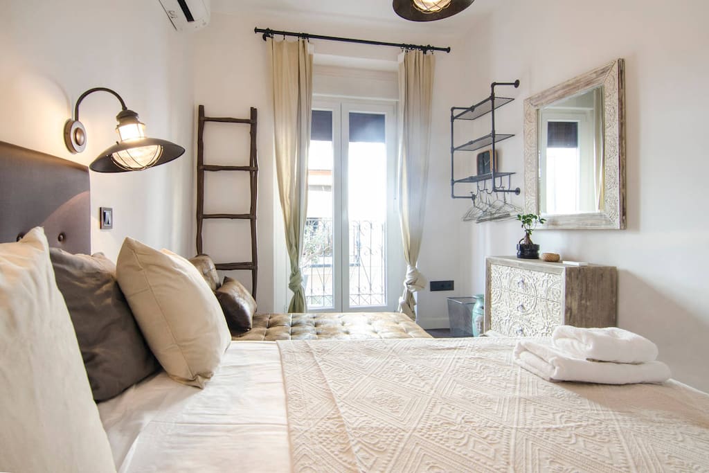 Master bedroom with vintage designer furniture and lamps.