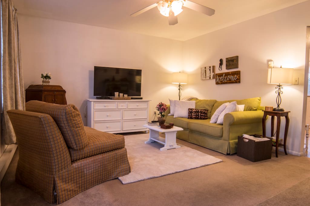 Couch and two chairs are provided for TV viewing.