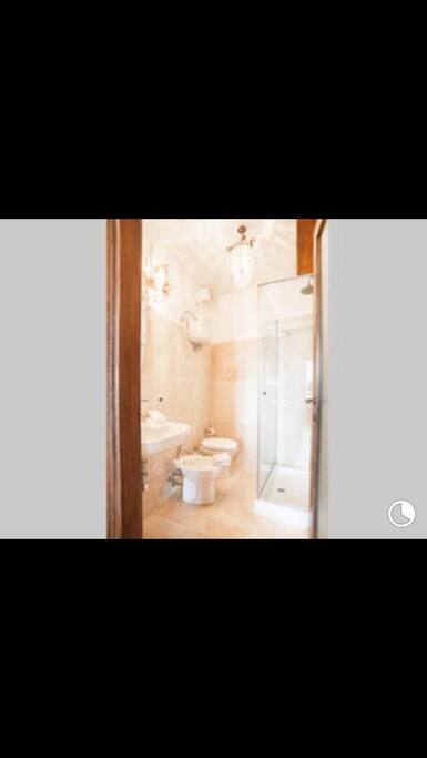 Lovely bathroom with Carrera marble floor & detailing with vintage Lighting