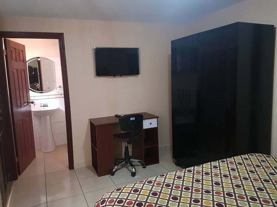 Room includes desk, cable TV, wardrobe, A/C, and complimentary Wi-Fi