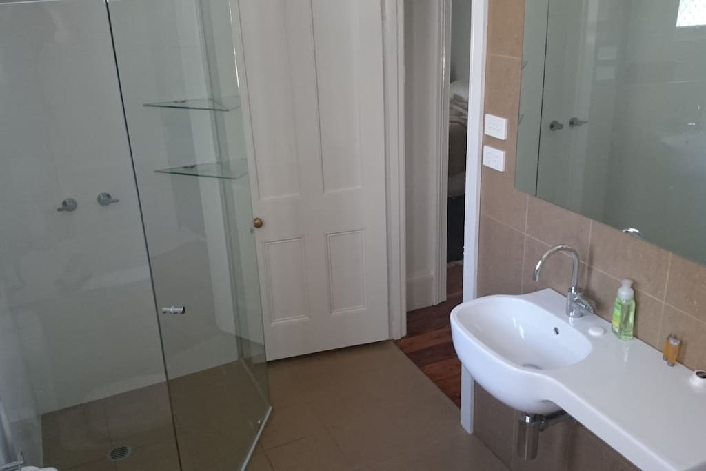 Newly renovated bathroom, including shower, bath and toilet.