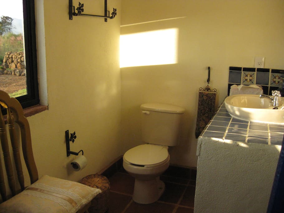Compact toilet and shower with views over the fields and mountains.