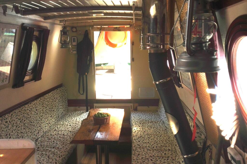 Looking forward from the galley to the lounge area and beyond to the outside of the boat