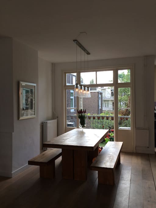 Dining area with double doors opening on balcony