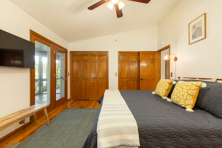 Main floor king bedroom with porch and own bathroom.