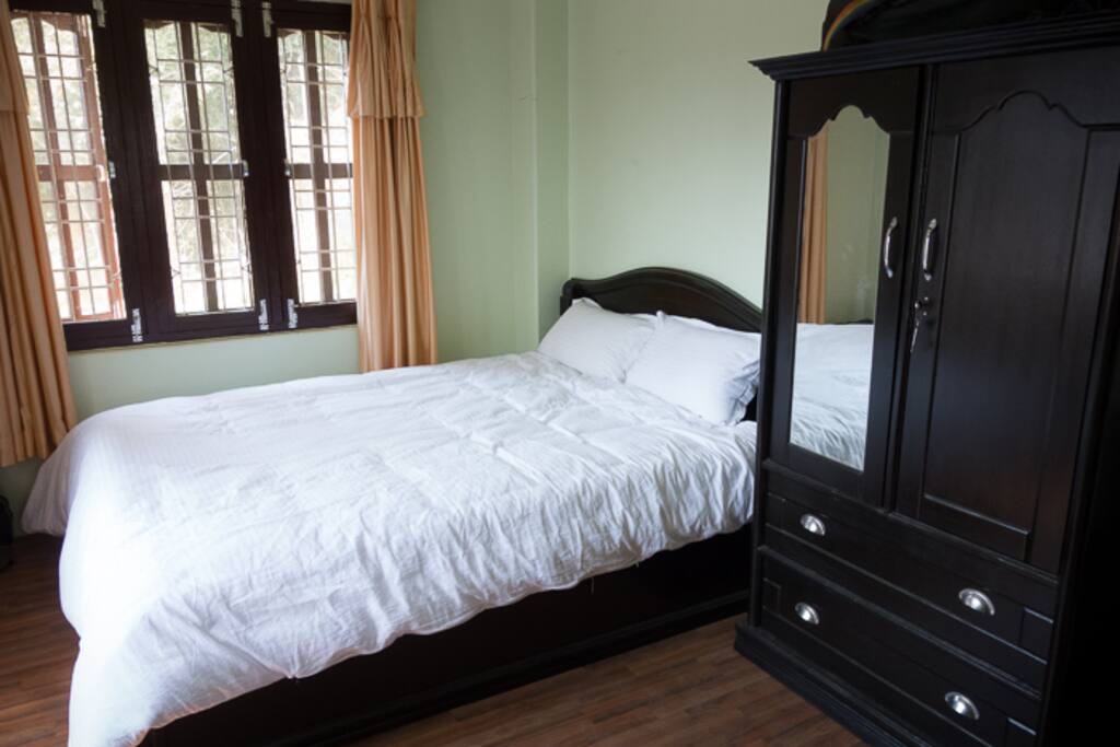 Bedroom with queen-size bed and wardrobe