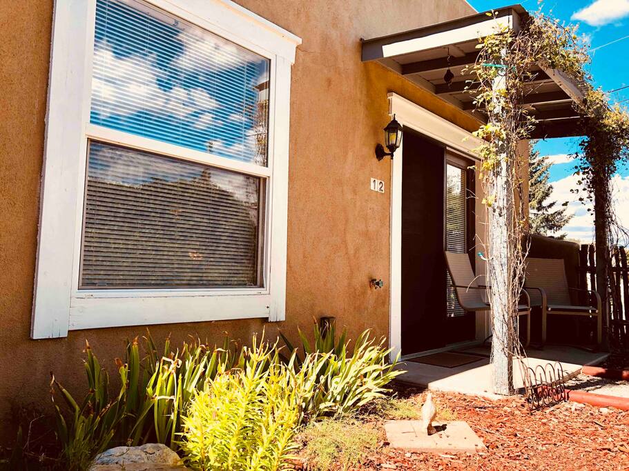 Front entrance to the adobe suite, private patio, and walkway to provided parking.