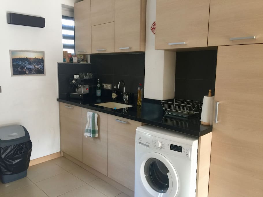Granite countertops, a deep sink, and a new washing machine.