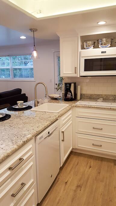 Kitchen with Convection/Microwave Oven, Fridge, Cook Top, Dishwasher, Disposal, Magic Bullet, Toaster, Coffee Maker & Electric Tea Kettle, Dishes, etc.