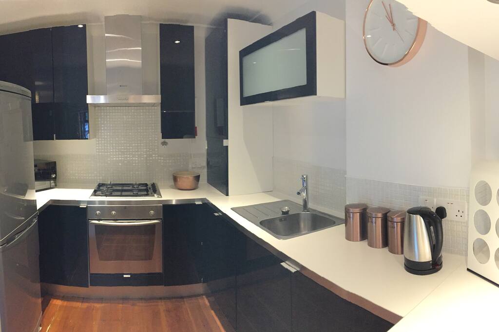 Uncluttered kitchen with all essentials provided including tea & coffee - just bring your own milk.