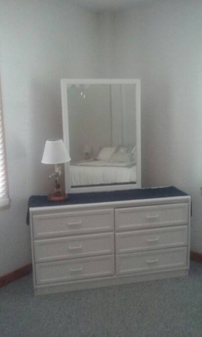 Six drawer dresser with mirror in bedroom