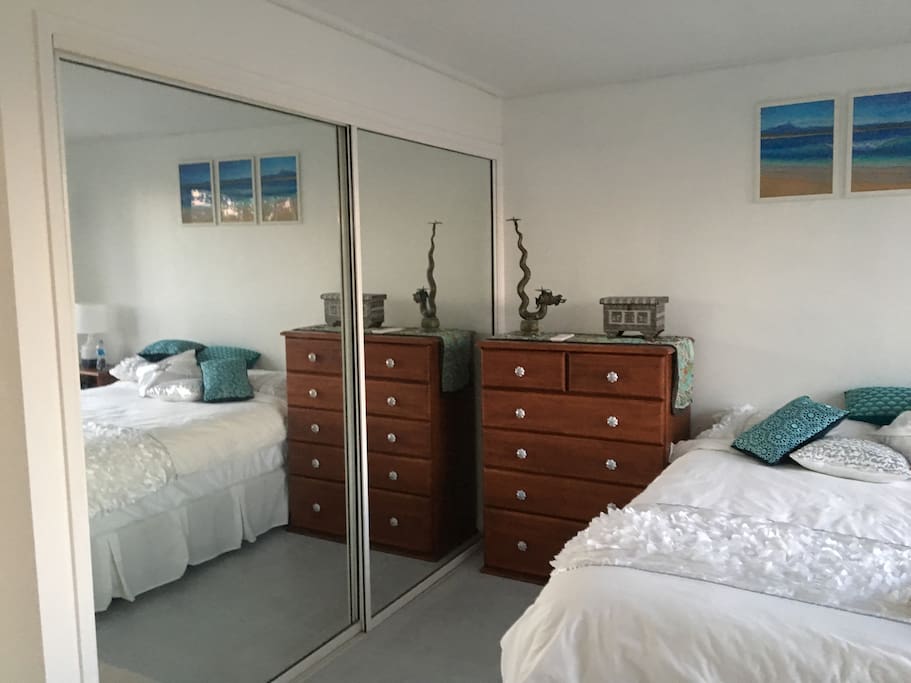 Bedroom with wardrobe and drawers available for use.
