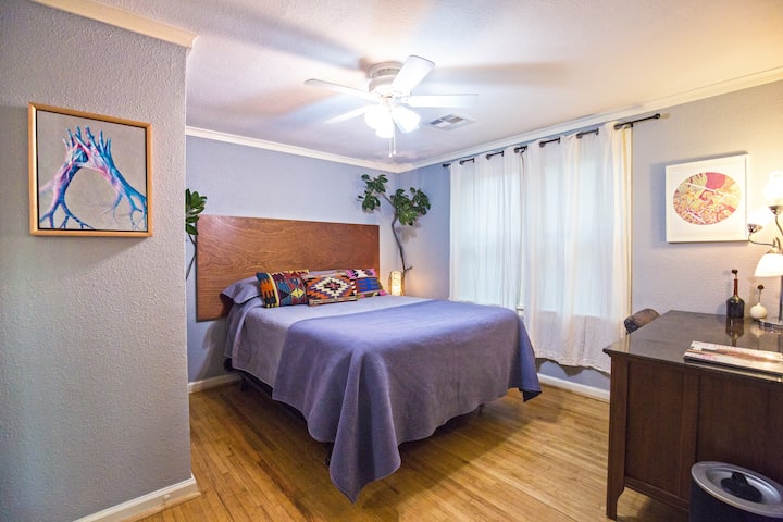 Queen bedroom, with cedar hanging closet,  large office desk, and multi level lighting. Never too bright, always relaxing with extra pillows and South facing windows. 