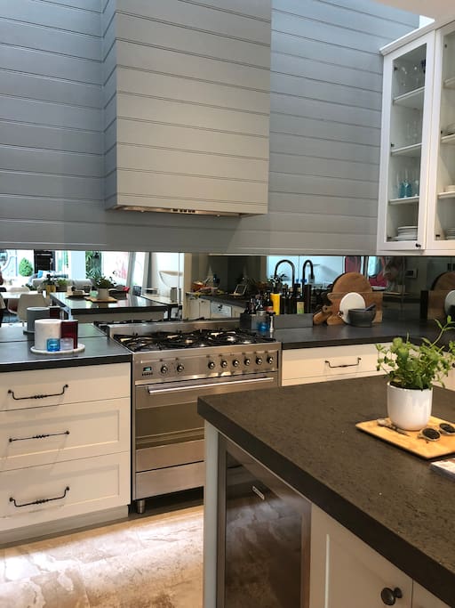 Kitchen area with island bench. Double sized oven and gas top.