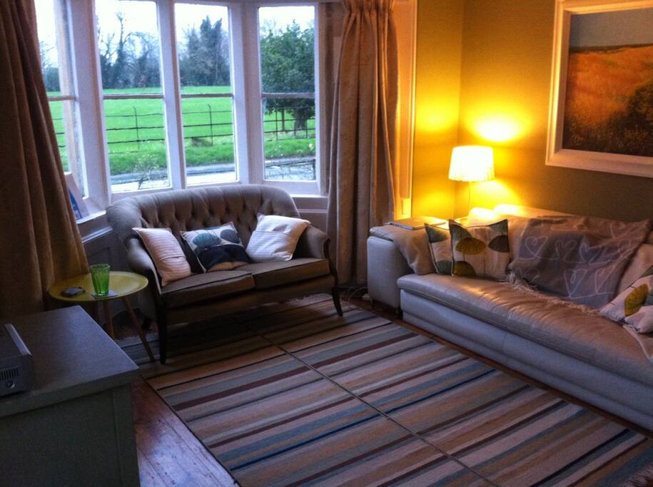 Living room: views onto the field in front of the house.