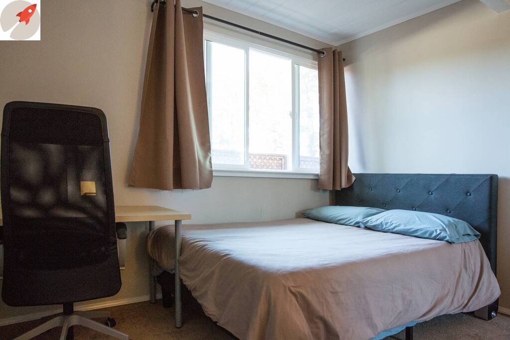 This home has queen sized bed and desk, with bright windows