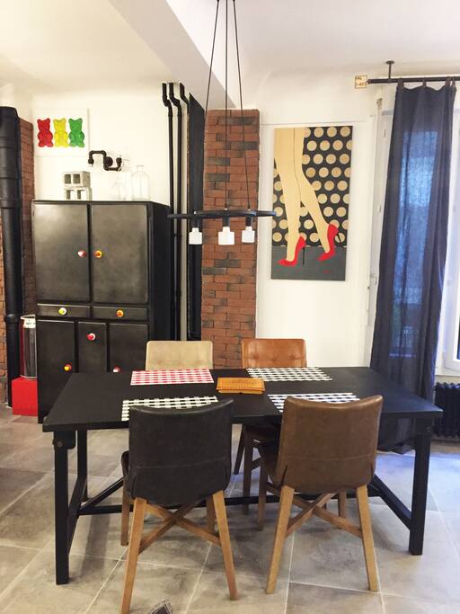 View of the dining table with cupboard in the background.