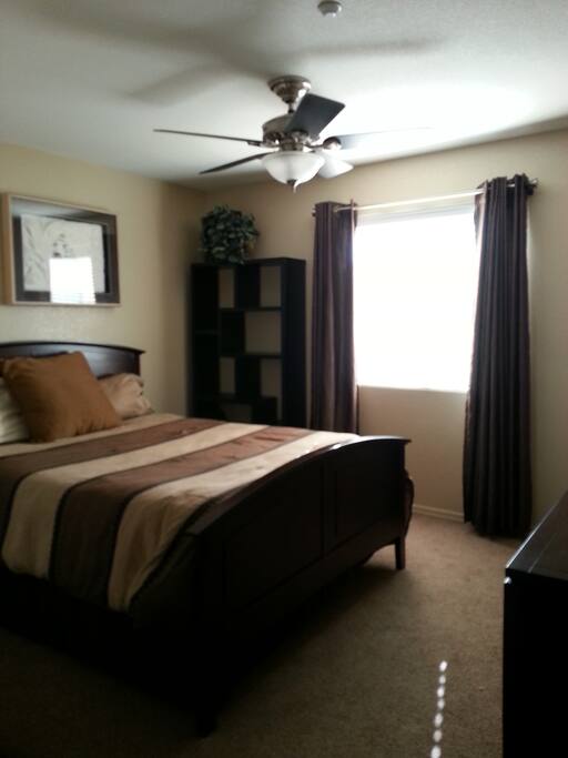 Master bedroom feature a queen size bed, ceiling fan, walkin-in closet and private bathroom.