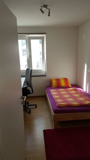 Your private bedroom with a comfortable bed, a desk and a window for fresh air and sunlight.