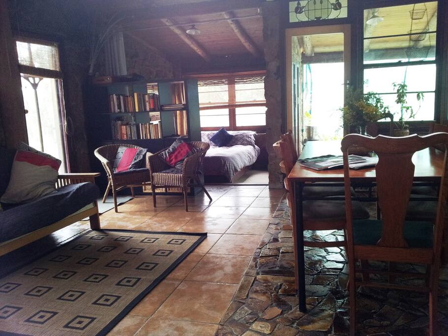 Looking through living room to sunroom double bed and screened veranda, futon couch also fold out to double bed