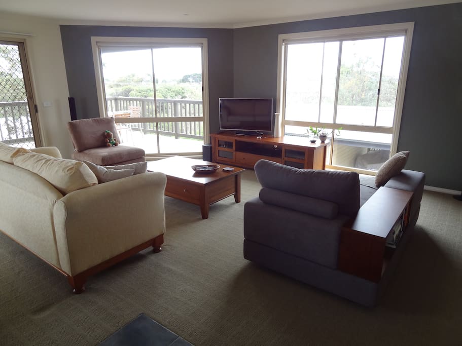 Bright open upstairs living area with views to the inlet.