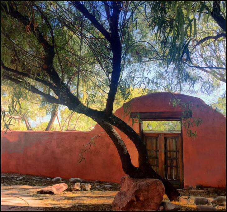 Encircled by an adobe wall for privacy.