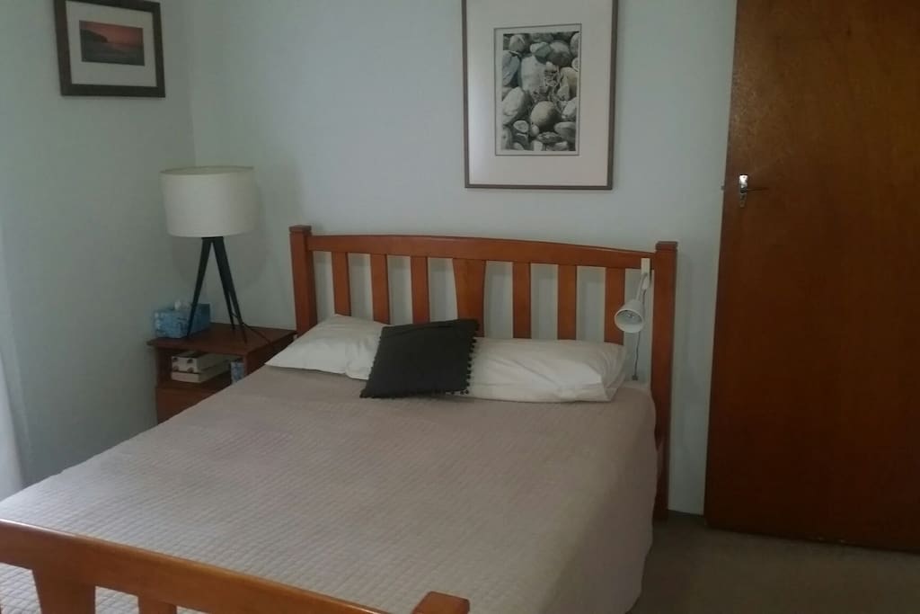 Queen Size Bed in light and bright room.