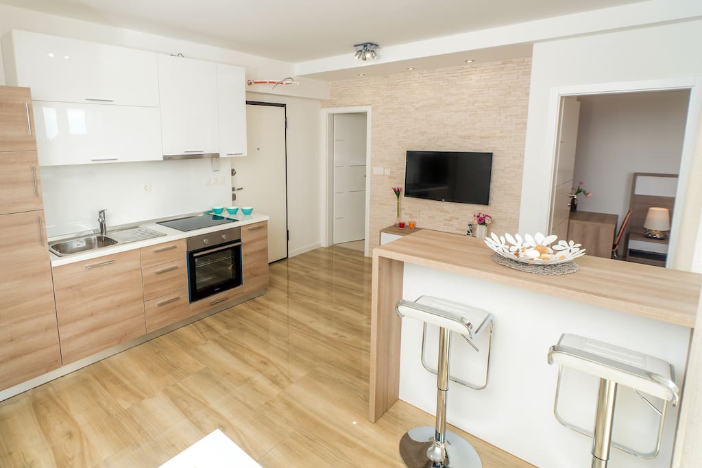 Kitchen is fully equipped with oven, stove, hood and refrigerator