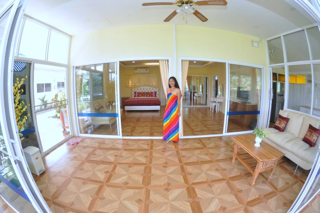6m x 3m Indoor Balcony Room with comfy sofa, ceiling fan and glass sliding doors with mosquito nets.
