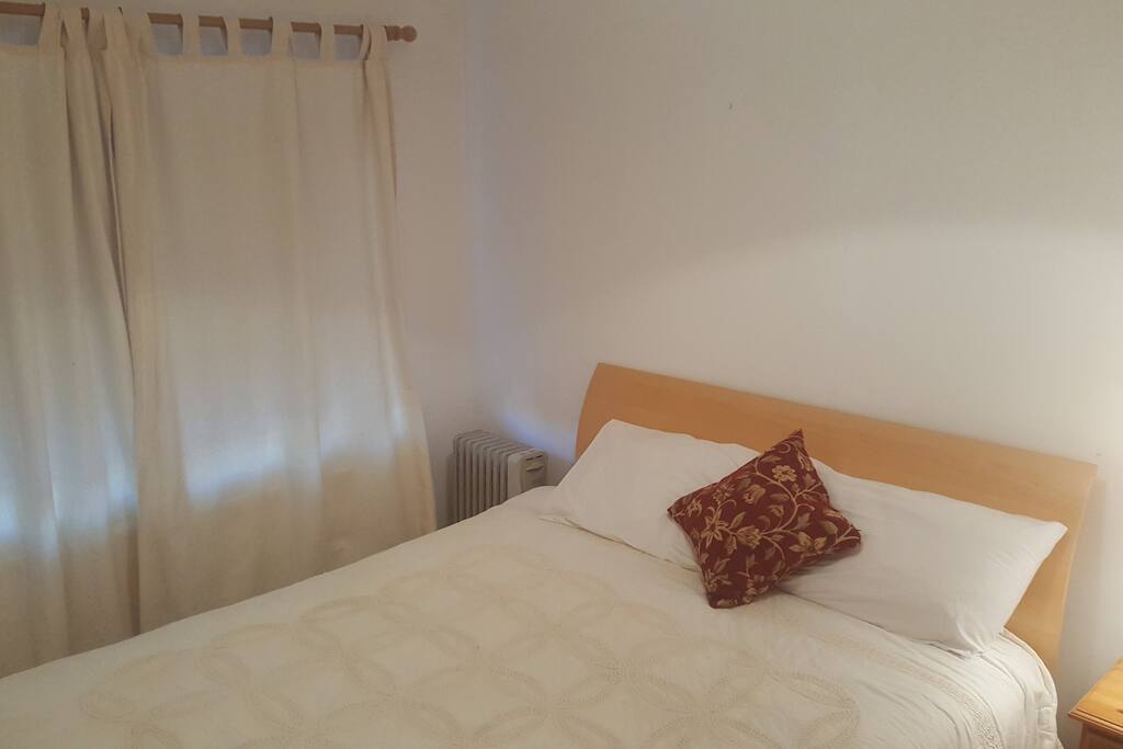 Comfortable bedroom with large cabinet.