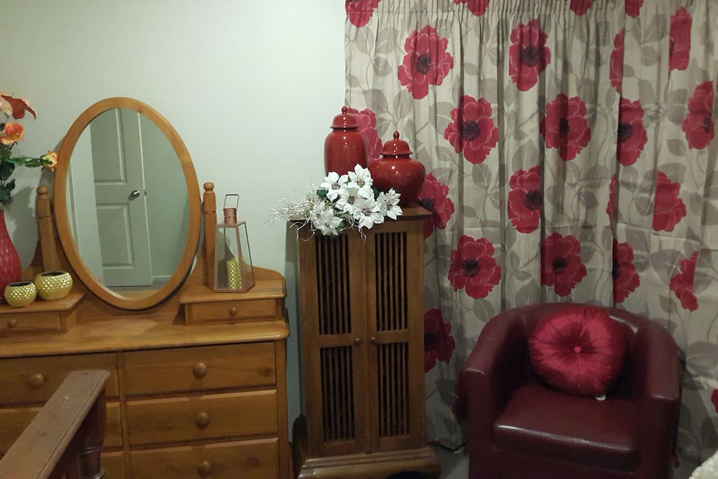 Relaxing chair in bedroom with double bed
