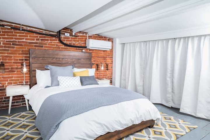 A comfortable queen bed in the loft