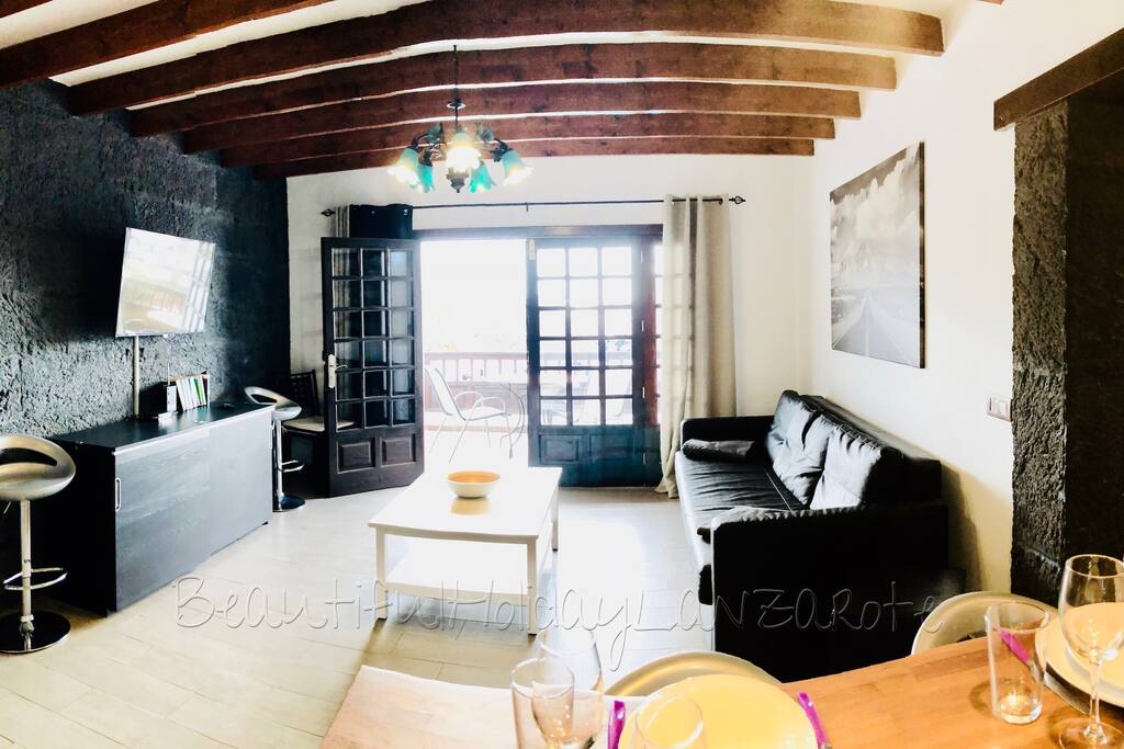 living room with satellite tv, wifi and kitchen area