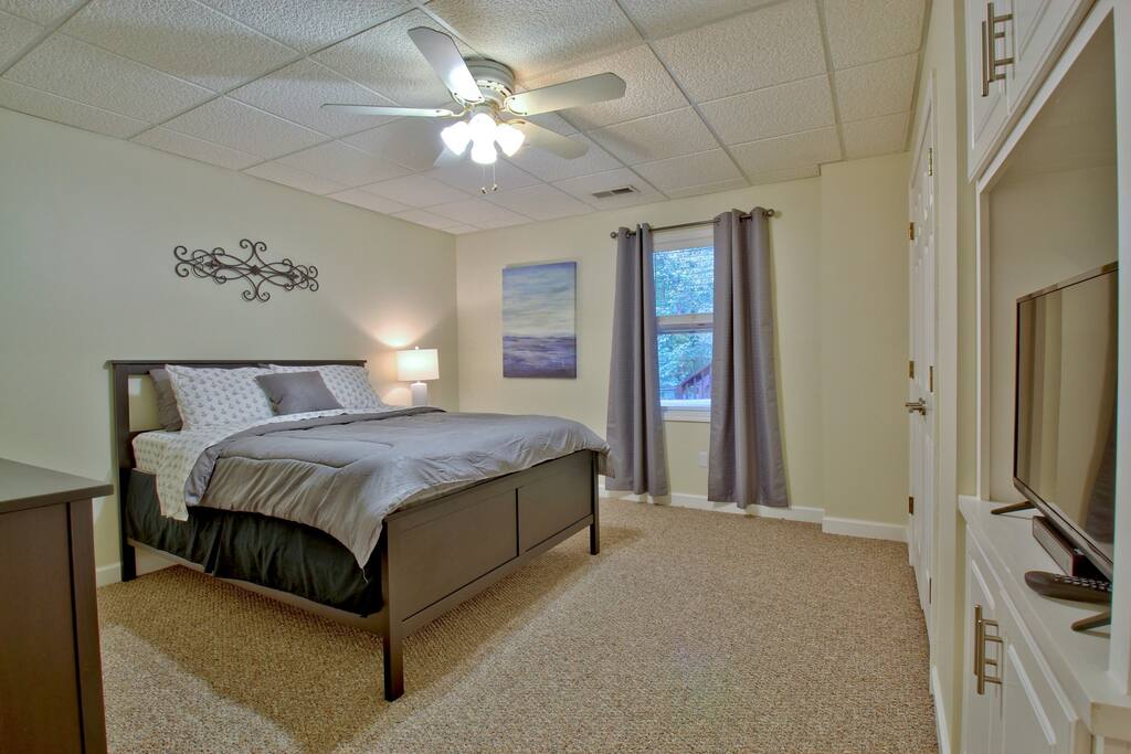 Bedroom with queen-sized bed and HDTV