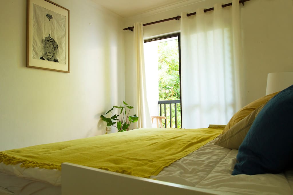 Bedroom 2 with balcony overlooking tropical garden