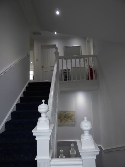 Staircase from front door , downstairs shower room and utility room to the main rooms