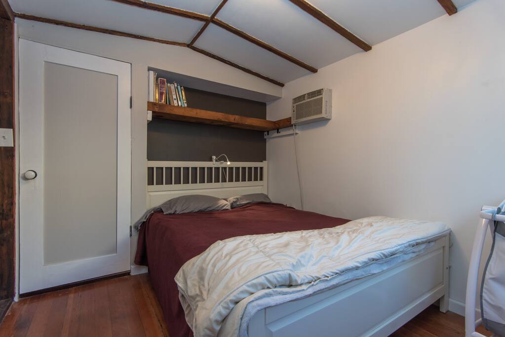 a cozy bed with a reading light