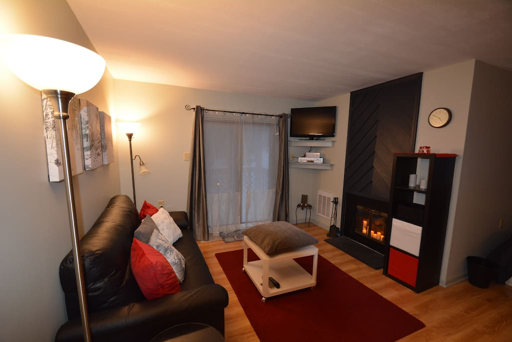A Roomy Living Room with Candle Fireplace, TV, A Place to Put Your Feet Up