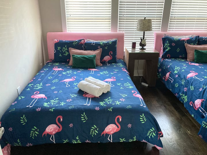 Main floor bedroom features two queen size beds.